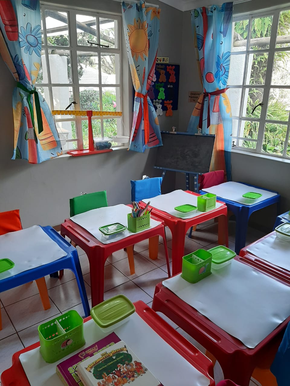 Colourful classroom tables ready for learning