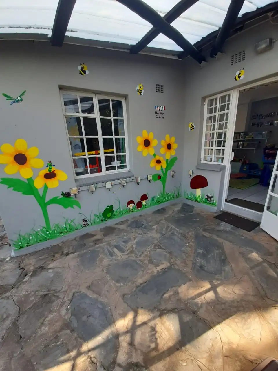 Sunflower and bee mural at the school entrance